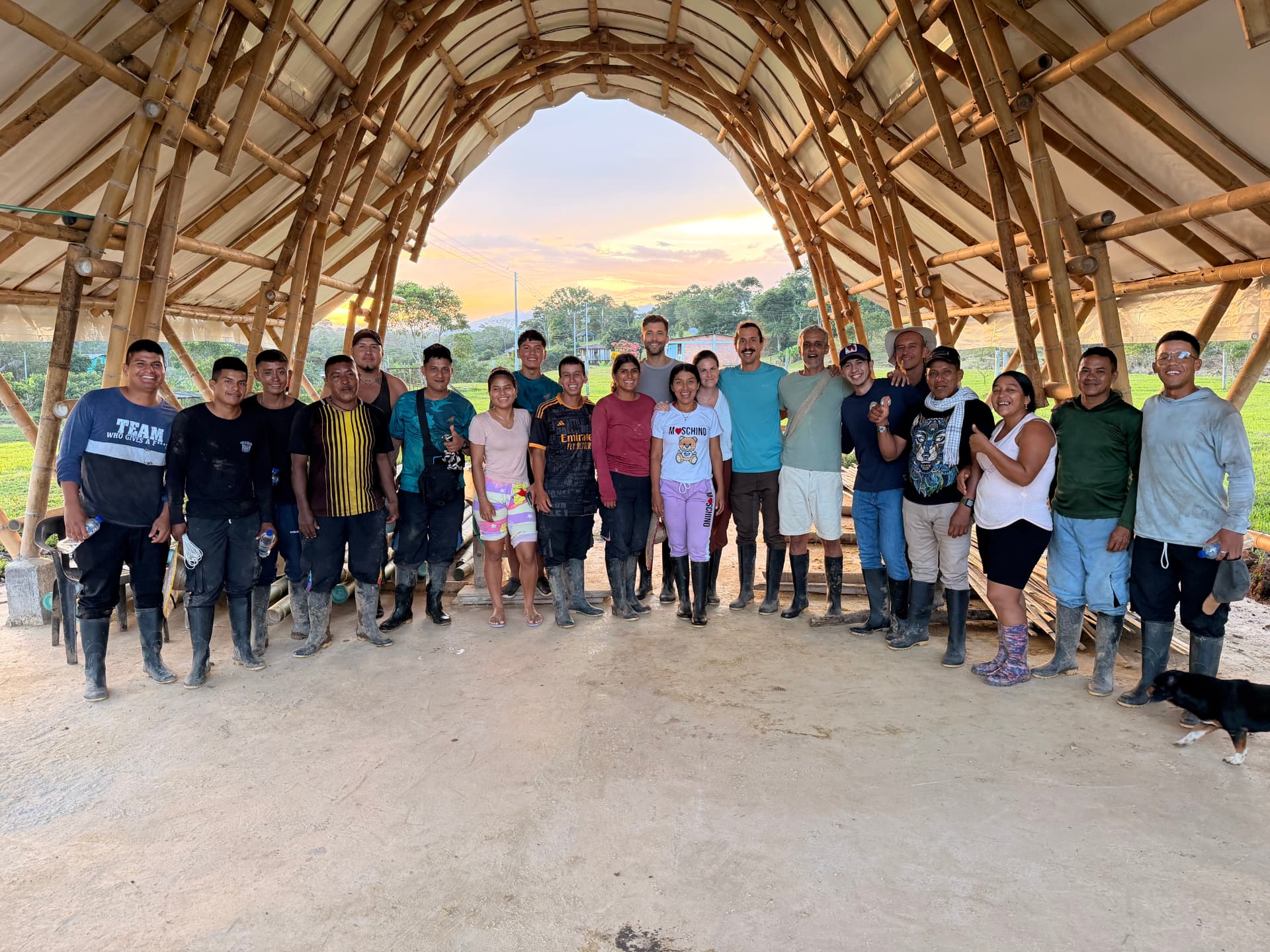 The bamboo crew gathered under the community structure at sunset