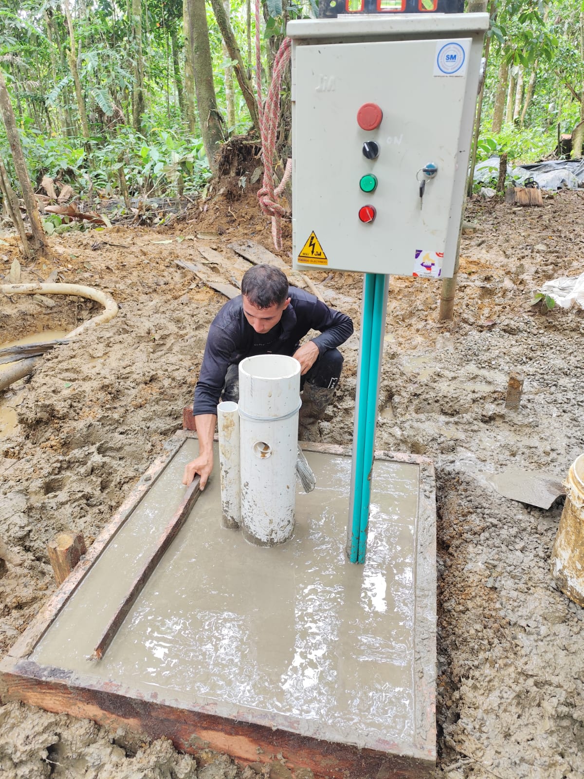 Finishing the concrete pad and control box at the new water well